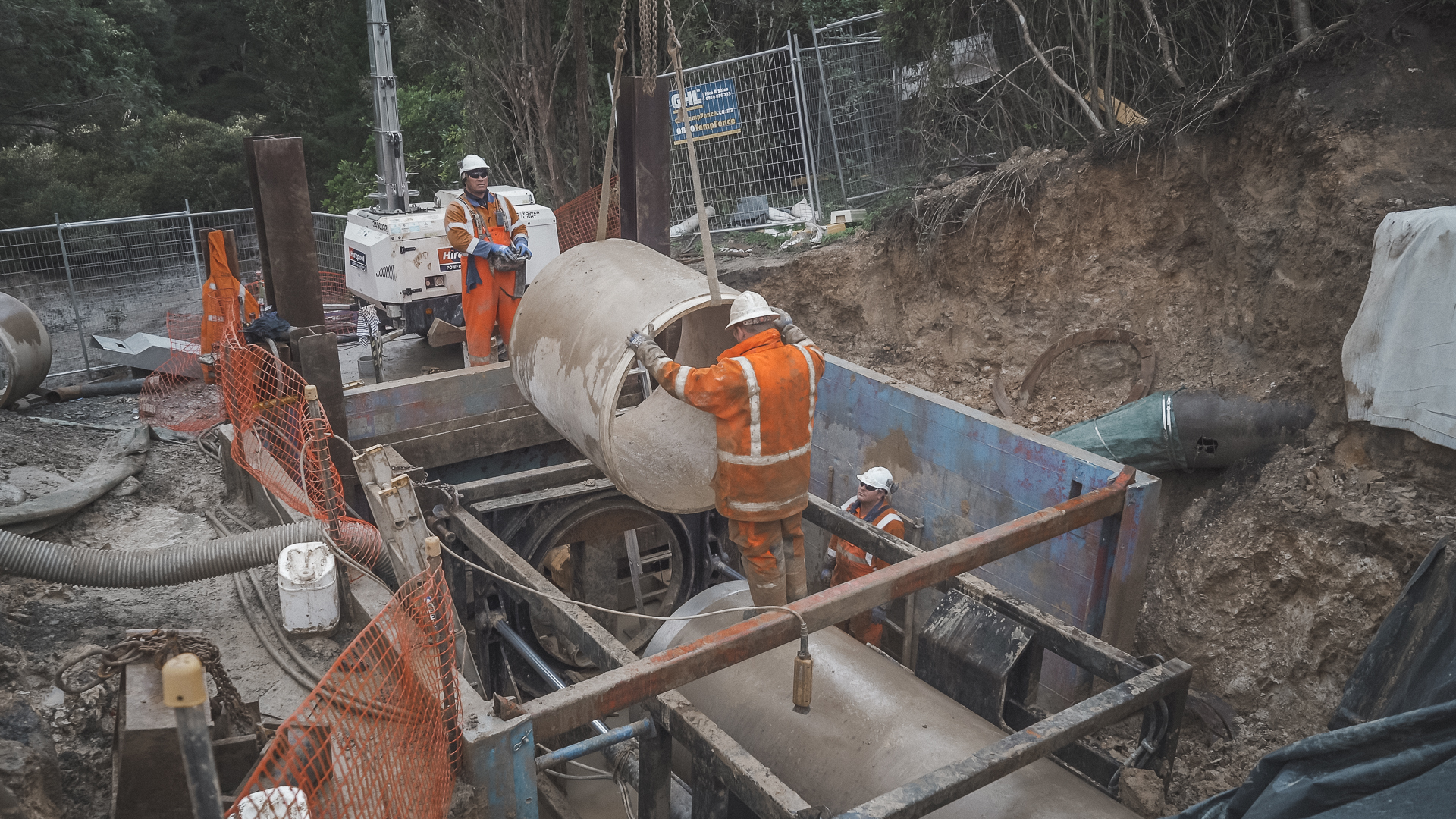 Crew lowering concrete pipe